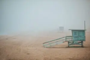 a lone lifeguard tower on the sand of Manhattan Beach